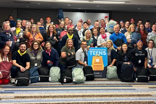 Team donating backpacks for teens in foster care