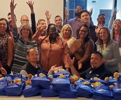 Corporate group celebrating after assembling stuffed animals through Bears for Kids