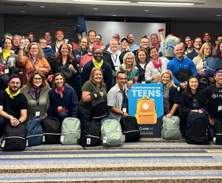 Team donating backpacks for teens in foster care
